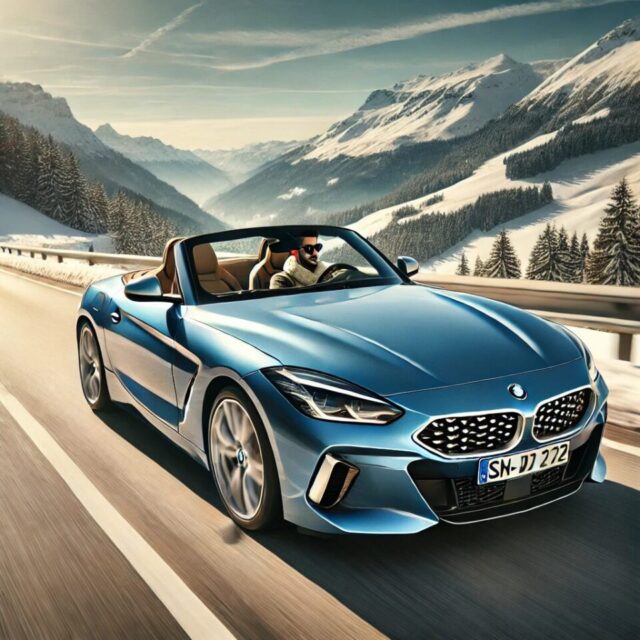 青いBMW Z4コンバーチブルが冬の山道をオープンで走行している様子。ベージュの高級レザーシートが見え、ドライバーはサングラスとマフラーを着用し、冬の澄んだ空気を楽しんでいる。背景には雪山と青空が広がり、メタリックボディは太陽の光を反射して美しく輝いている。